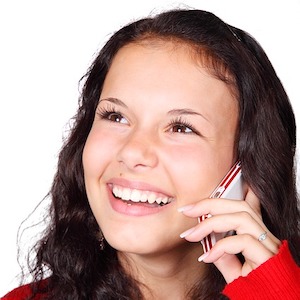 Girl on phone making cold calls